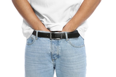 Photo of Man scratching crotch on white background, closeup. Annoying itch