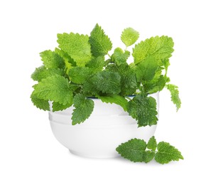 Photo of Bowl with fresh green lemon balm leaves isolated on white