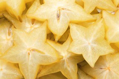 Photo of Pile of delicious carambola slices as background, top view