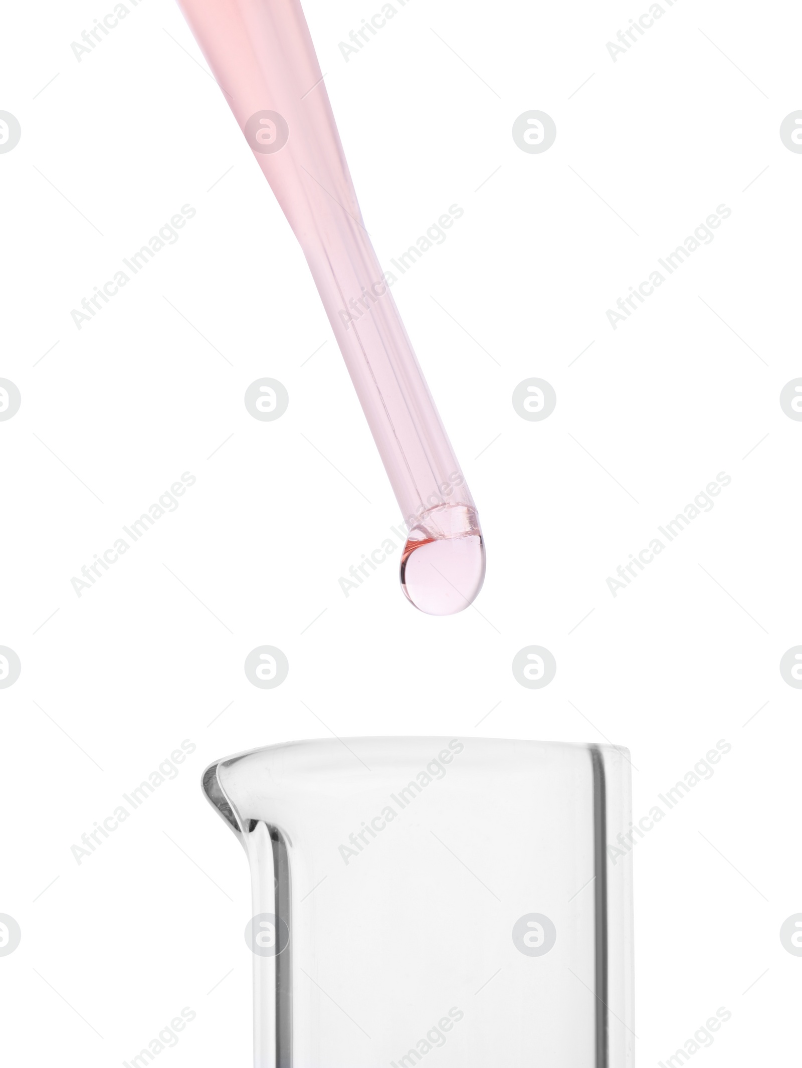 Photo of Dripping liquid from pipette into beaker on white background, closeup