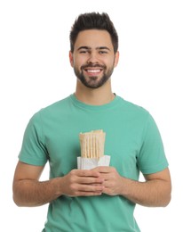 Happy young man holding tasty shawarma isolated on white