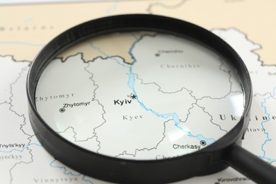 MYKOLAIV, UKRAINE - NOVEMBER 09, 2020: Kyiv city marked on map of Ukraine, view through magnifying glass