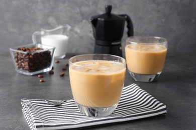 Photo of Glass with cold brew coffee and milk on table