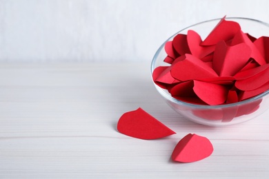 Red paper hearts on white wooden table. Space for text