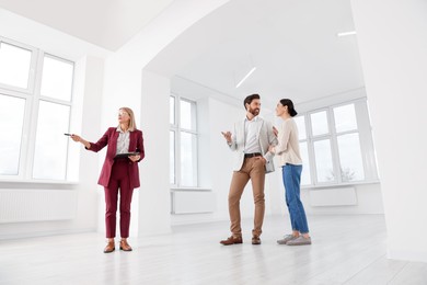 Real estate agent showing new apartment to couple