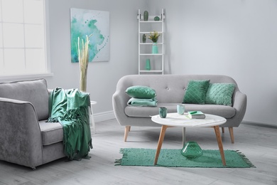 Living room interior with comfortable armchair and sofa. Mint color decors