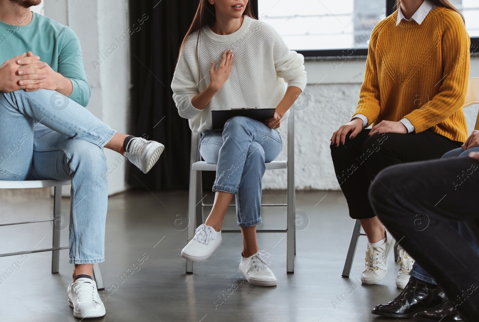 Photo of Psychotherapist working with patients in group therapy session, closeup