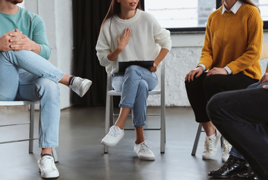 Photo of Psychotherapist working with patients in group therapy session, closeup