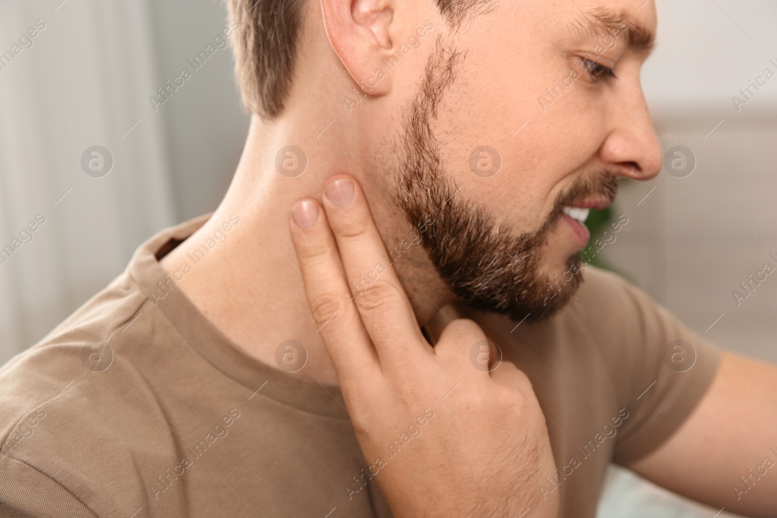 Photo of Man checking pulse with fingers at home, closeup