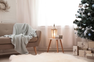Stylish living room interior with decorated Christmas tree