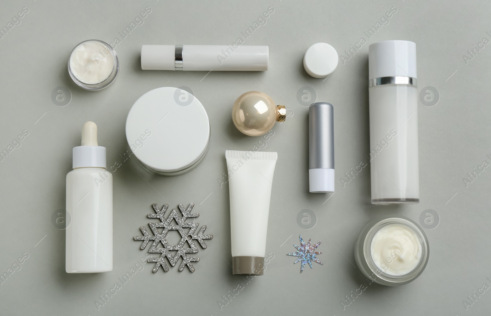 Photo of Flat lay composition with different cosmetic products on light grey background. Winter care