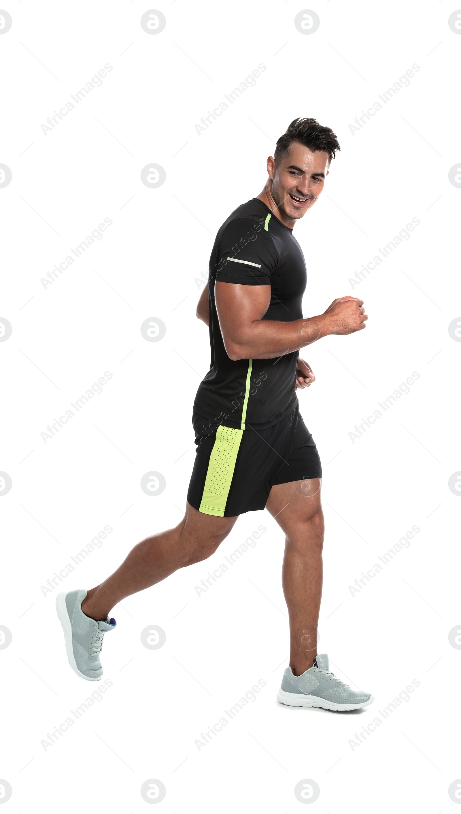 Photo of Sporty young man running on white background