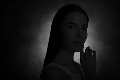 Image of Silhouette of woman in darkness. Portrait on black background