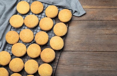 Many tasty sugar cookies on wooden table, top view. Space for text