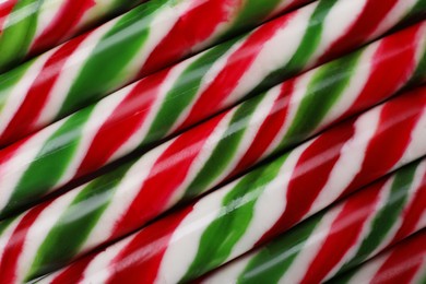 Photo of Top view of many sweet Christmas candy canes as background, closeup