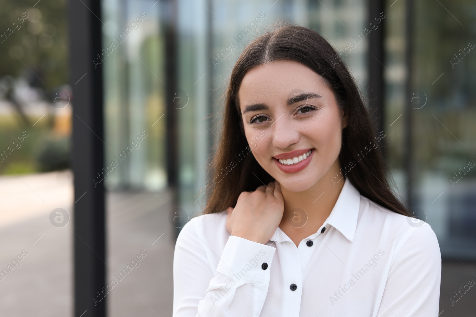 Photo of Portrait of beautiful woman outdoors. Attractive lady smiling and looking into camera. Space for text