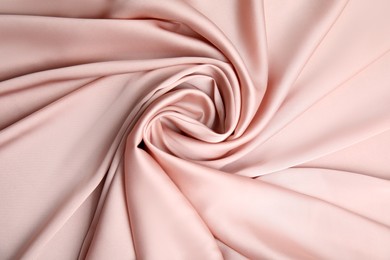 Photo of Texture of delicate pink silk as background, top view