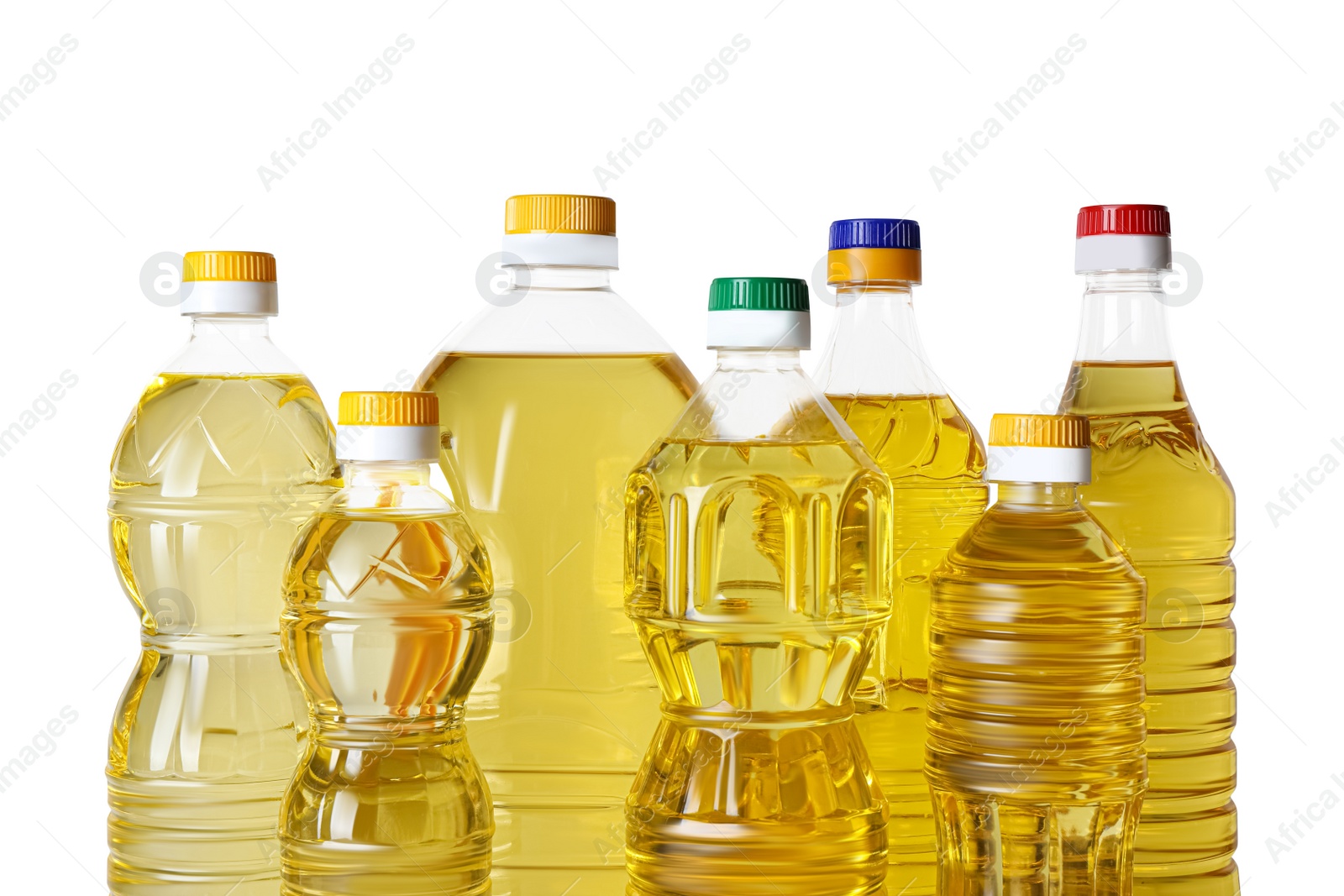 Photo of Bottles of cooking oil on white background