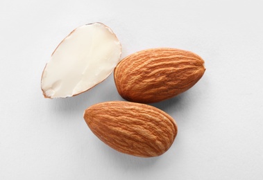 Photo of Organic almond nuts on white background, top view. Healthy snack