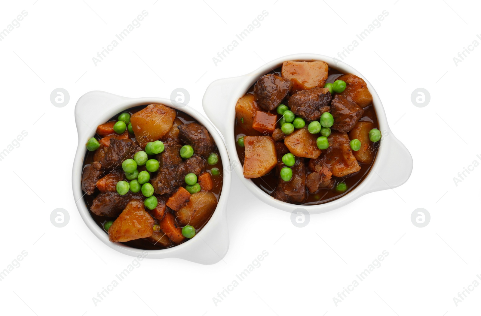 Photo of Delicious beef stew with carrots, peas and potatoes on white background, top view