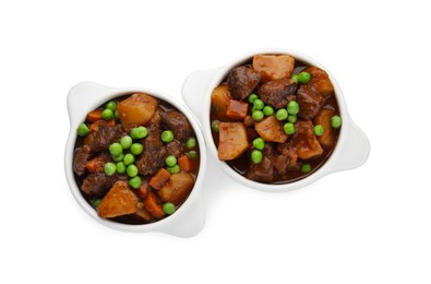 Photo of Delicious beef stew with carrots, peas and potatoes on white background, top view