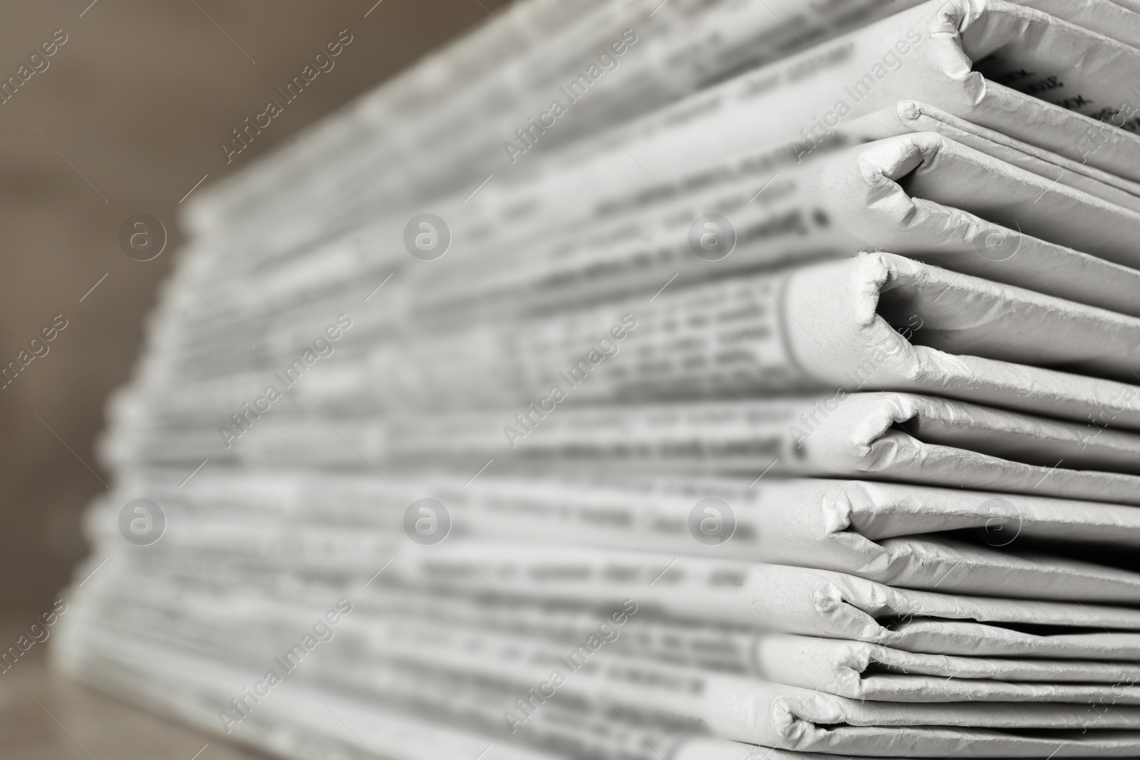 Photo of Stack of newspapers on table, closeup. Journalist's work