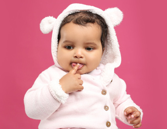 Photo of Cute African American baby on pink background