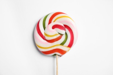 Photo of Stick with bright lollipop on white background, top view