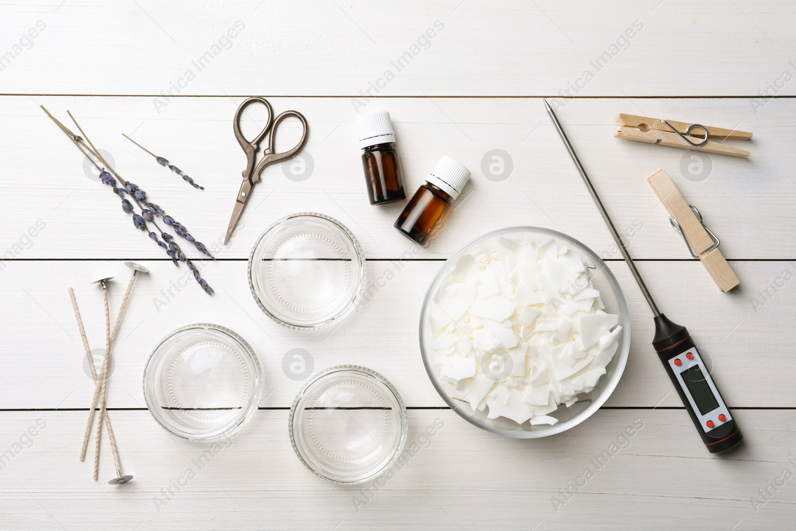 Photo of Flat lay composition with ingredients for homemade candles on white wooden background