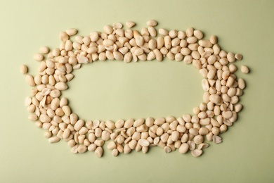 Composition with peanuts and space for text on color background, top view