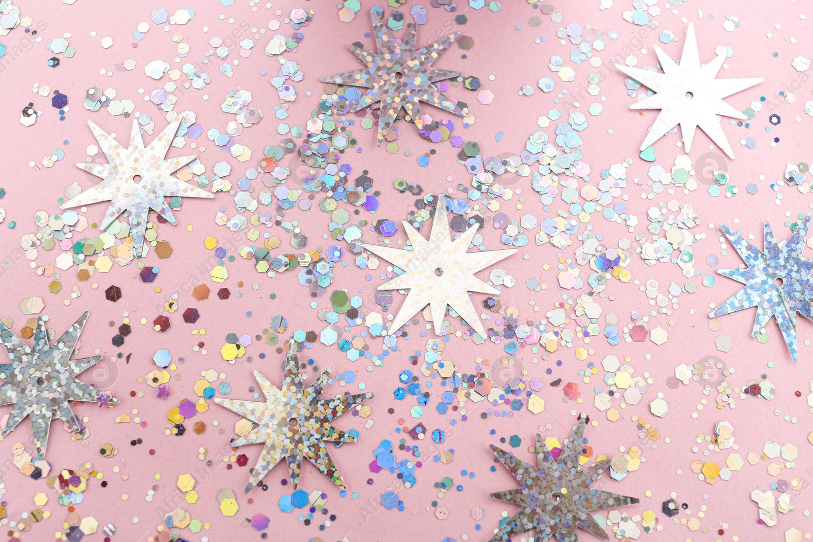 Photo of Shiny glitter on light pink background, flat lay