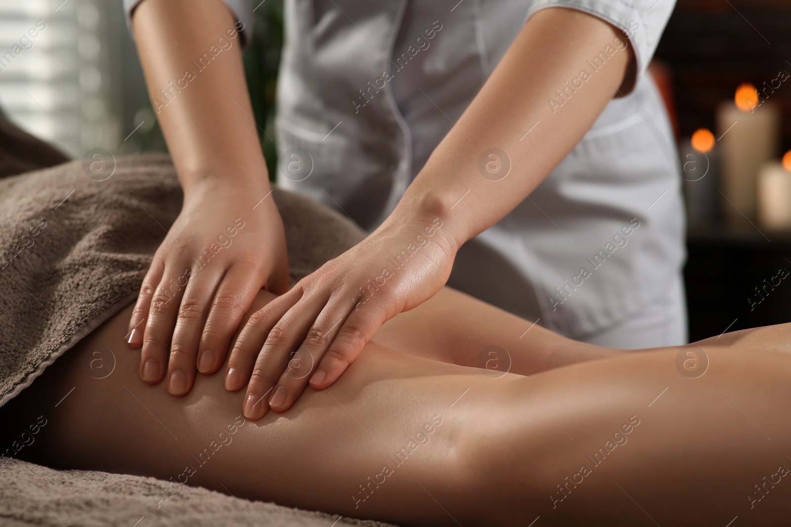 Photo of Woman receiving leg massage in spa salon, closeup