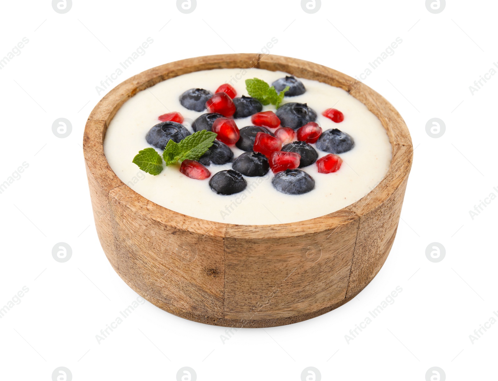 Photo of Bowl of delicious semolina pudding with blueberries, pomegranate and mint isolated on white