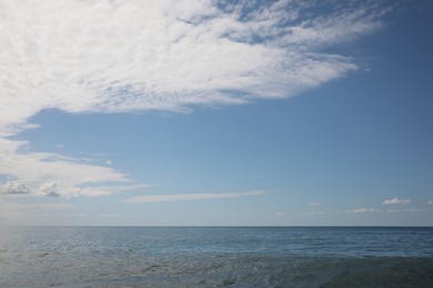 Photo of Picturesque view of sea under beautiful blue sky with fluffy clouds