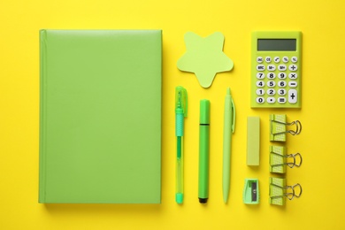 Photo of School stationery on yellow background, flat lay