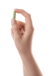 Photo of Woman holding vitamin capsule on white background, closeup. Health supplement