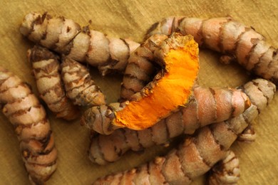 Many raw turmeric roots on table, flat lay