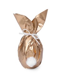 Photo of Easter bunny made of shiny gold paper and egg on white background