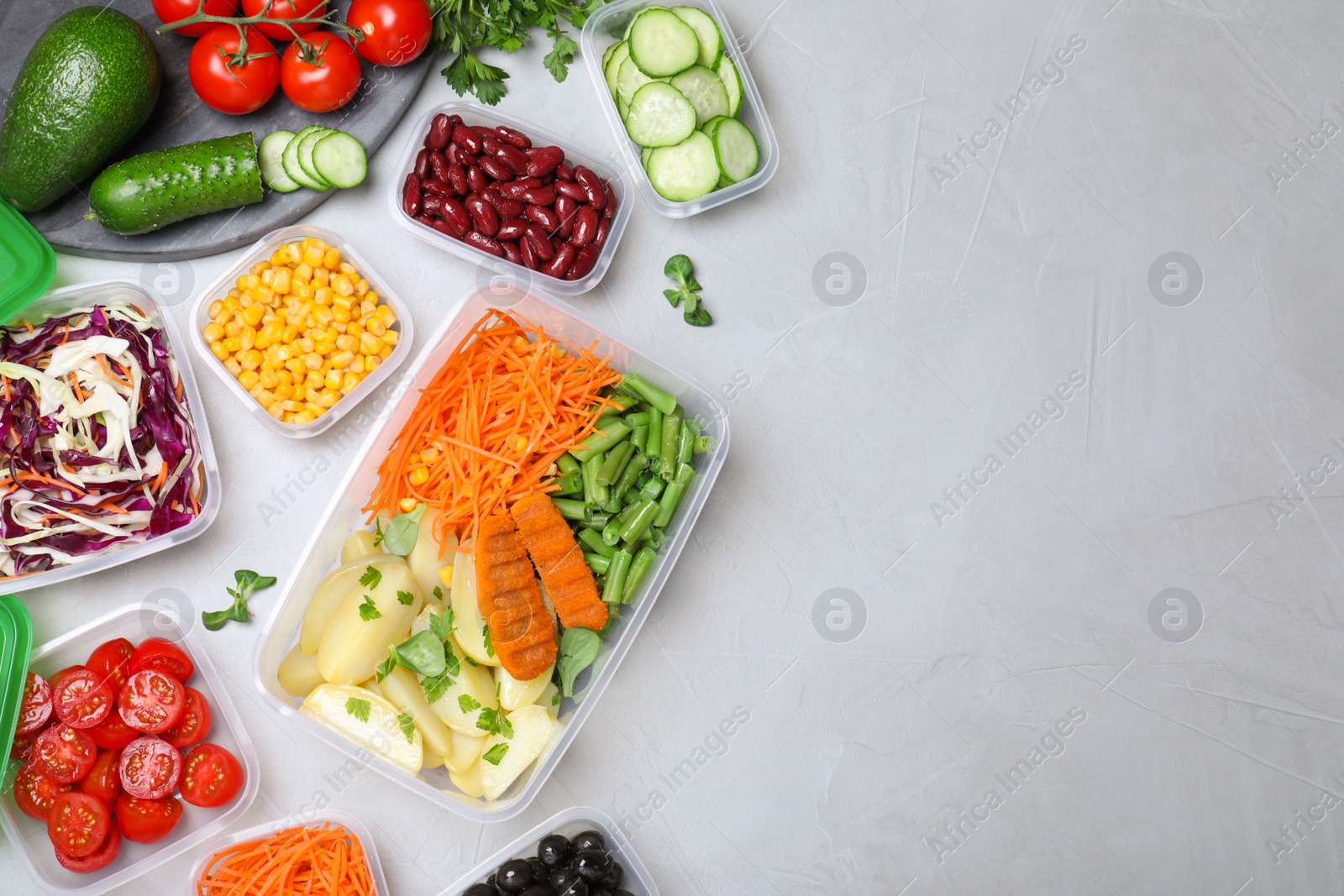 Photo of Set of plastic containers with fresh food on light table, flat lay. Space for text