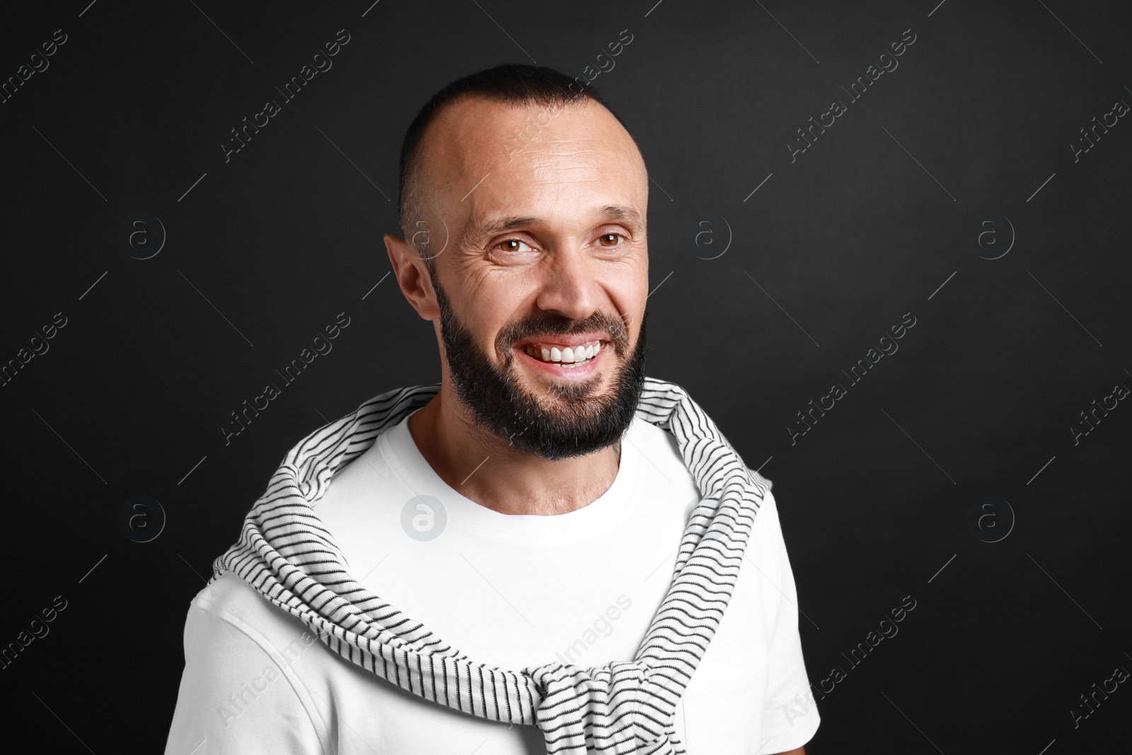 Photo of Portrait of handsome man on black background