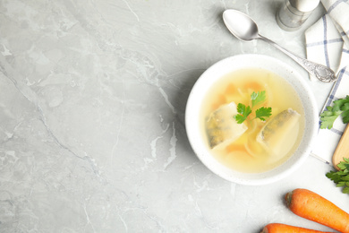 Photo of Delicious fish soup served on marble table, flat lay. Space for text