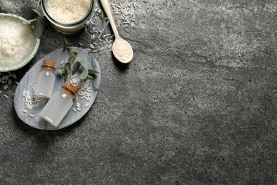 Photo of Flat lay composition with rice water on grey table. Space for text