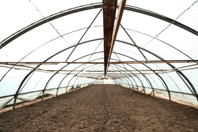 Photo of Large agricultural greenhouse prepared for seed sowing