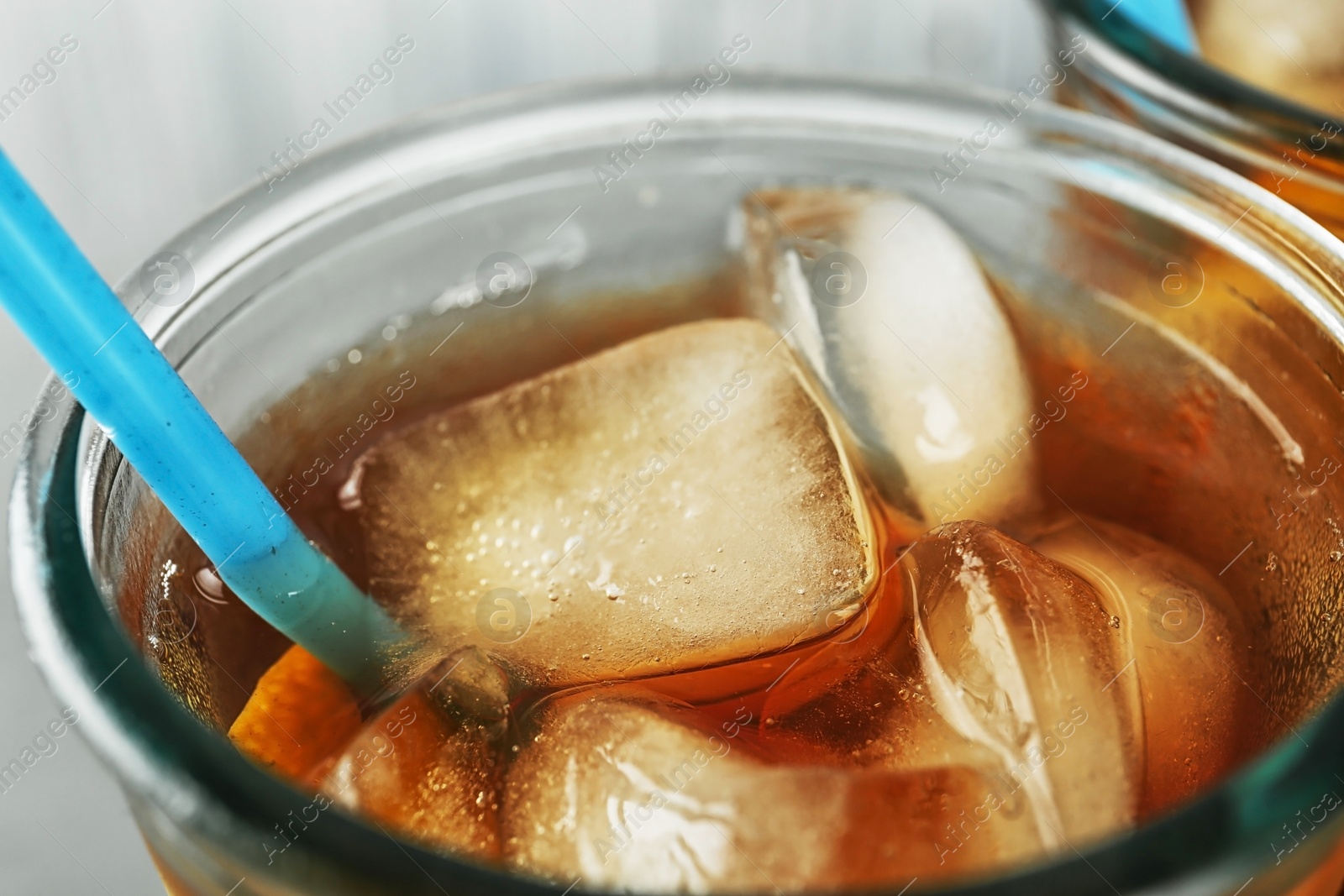 Photo of Glass of delicious refreshing iced tea, closeup