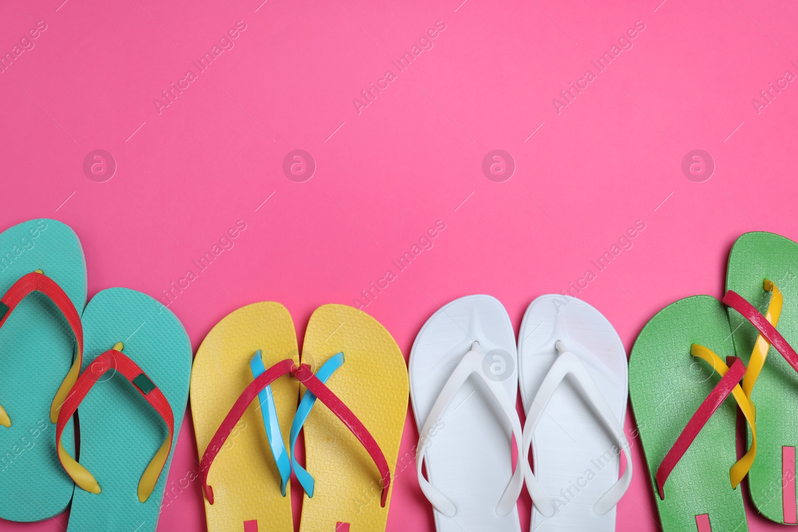 Photo of Many different flip flops on pink background, flat lay. Space for text