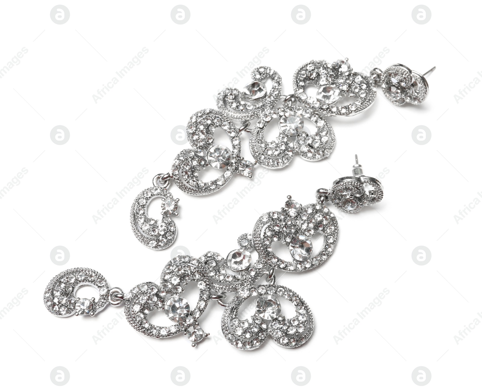 Photo of Beautiful silver earrings isolated on white. Luxury jewelry