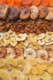 Different tasty dried fruits as background, top view