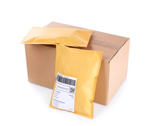 Photo of Padded envelopes and cardboard parcel on white background