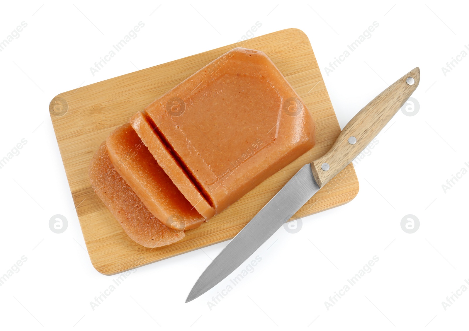 Photo of Delicious sweet quince paste and knife isolated on white, top view