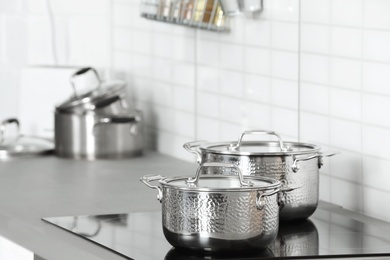 Photo of Clean pans on stove in kitchen. Space for text